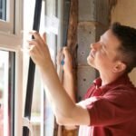 Technician from Quick Glass Repair replacing window glass in Falls Church VA
